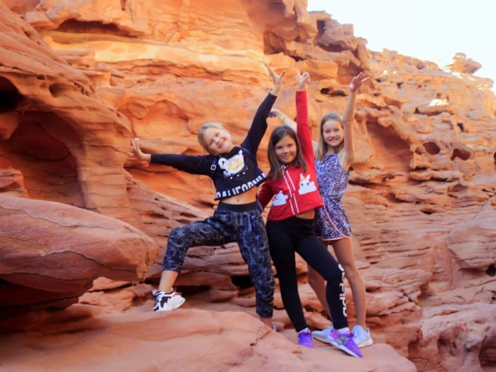 Guests posing in a sandstone canyon
