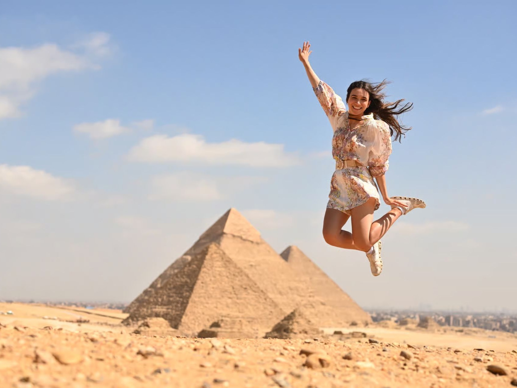 Traveller jumping in front of the Giza Pyramids