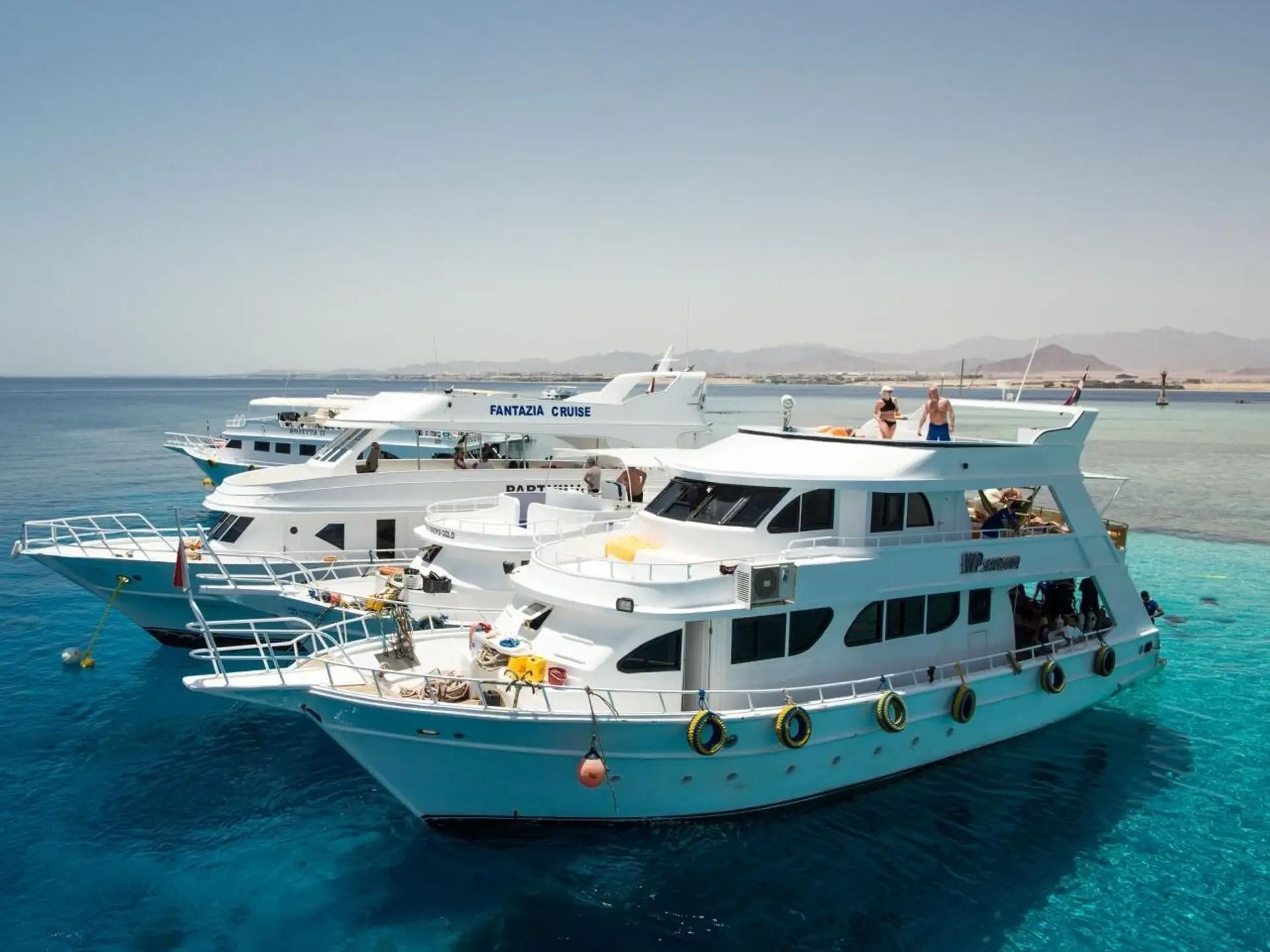 Tiran Island excursion boat on turquoise water