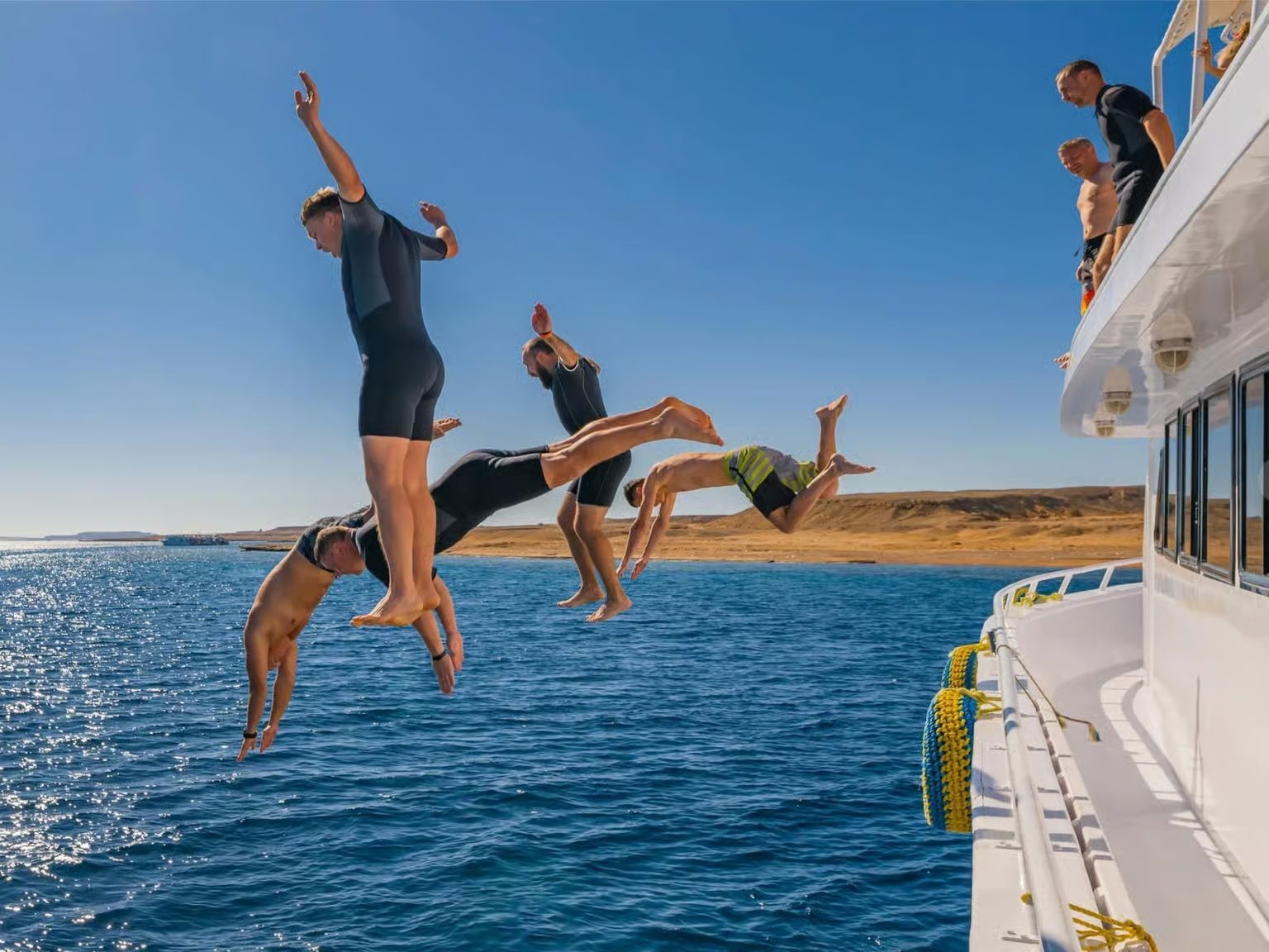 Guests jumping from the boat into the Red Sea