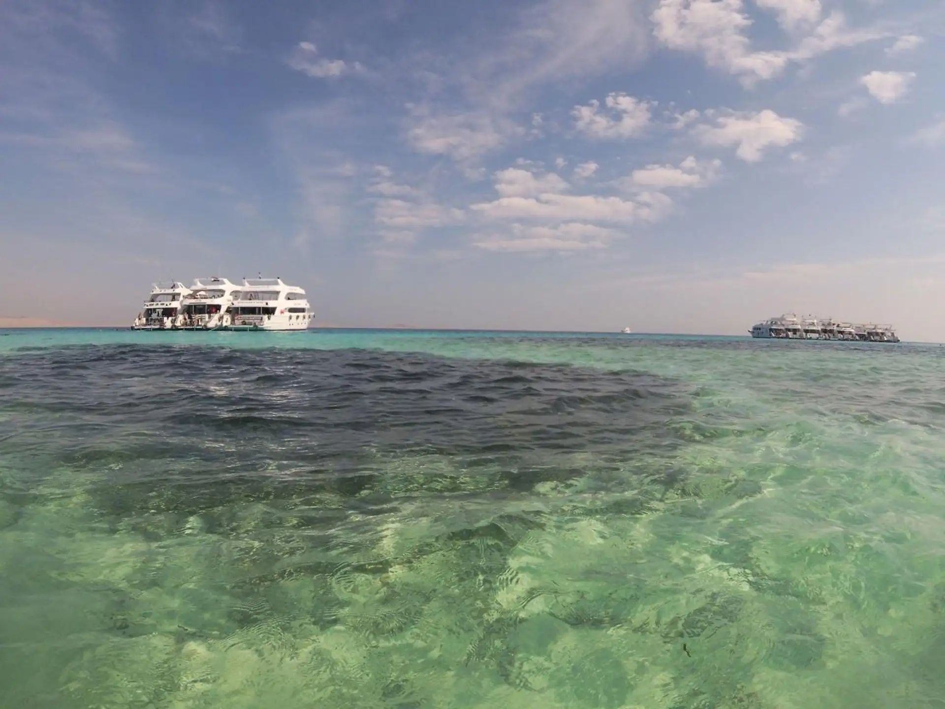 Boat anchored above shallow turquoise water
